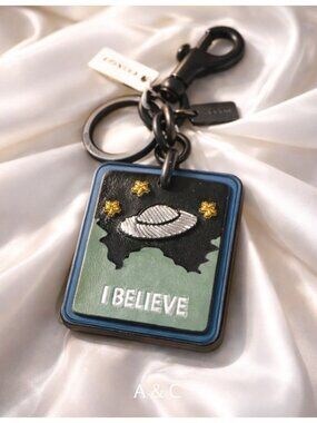 Coach UFO Bag Charm Keychain “I Believe” Glovetanned Leather Rare Space